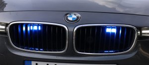 niebieskie światła błyskowe znajdujące się z przodu nieoznakowanego radiowozu marki BMW
